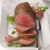 Roast beef on serving dish with fork